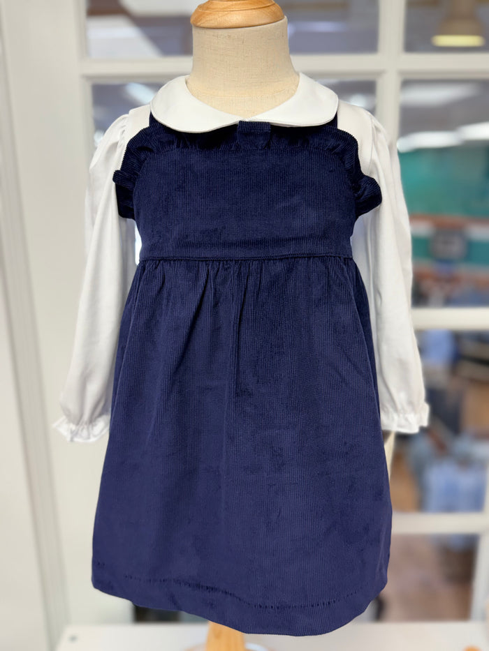 The Macy Drew Dress in Nantucket Navy Corduroy by The Beaufort Bonnet Company wraps your toddler in cozy elegance, perfectly layering over the Maude Peter Pan Collar White Shirt. Ideal for autumn and holiday moments, it invites warmth and timeless charm, with a monogram option for a personalized touch.