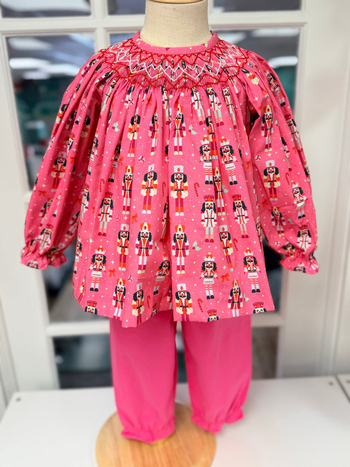 Celebrate the season with Cape Point Clothing Co.’s Nutcracker Bishop Pant Set! A charming pink nutcracker blouse paired with cozy pink corduroy pants wraps your toddler in warmth and festive joy, making chilly days feel magical and stylish. Perfect for creating unforgettable holiday memories.