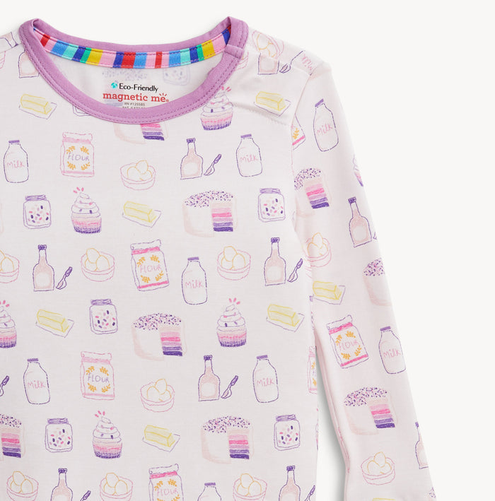 Wrap your little one in cozy comfort with the Bake Boss Modal Pajama Set by Magnetic Me. These bakery-themed pajamas, celebrating milk and cookies, spark joy and warmth on crisp fall evenings. Soft, breathable fabric ensures peaceful sleep and adorable style all night long!