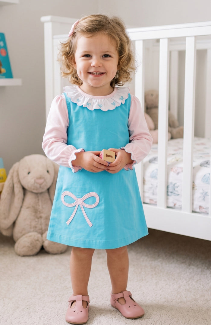 The Bow Hayden Jumper by Zuccini Kids wraps your little one in soft blue corduroy, beautifully accented with a delicate pink bow appliqué. Perfectly paired with a crisp white shirt, it brings timeless charm and comfort to every toddler’s day. White shirt not included.