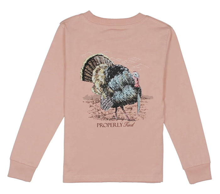 Celebrate autumn in vibrant style with the Boys Longsleeve Gobbler Tee by Properly Tied. This peachy long-sleeve shirt, featuring a playful turkey design, brings cozy comfort and festive spirit to every boy’s fall wardrobe. Perfect for toddlers to tweens ready to embrace the season!