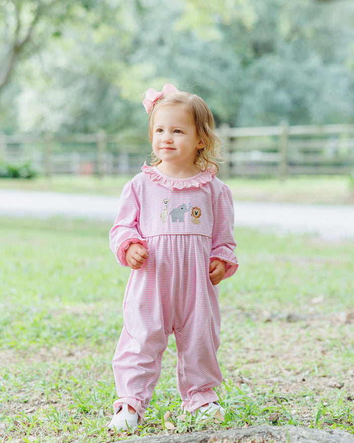 Let your little one’s imagination run wild in the Girls Zoo Crew Romper! Soft pink stripes and playful ruffles frame adorable zoo animal embroidery, creating a joyful outfit that sparks smiles and adventures at every turn. Ready to make every day a fun-filled safari?