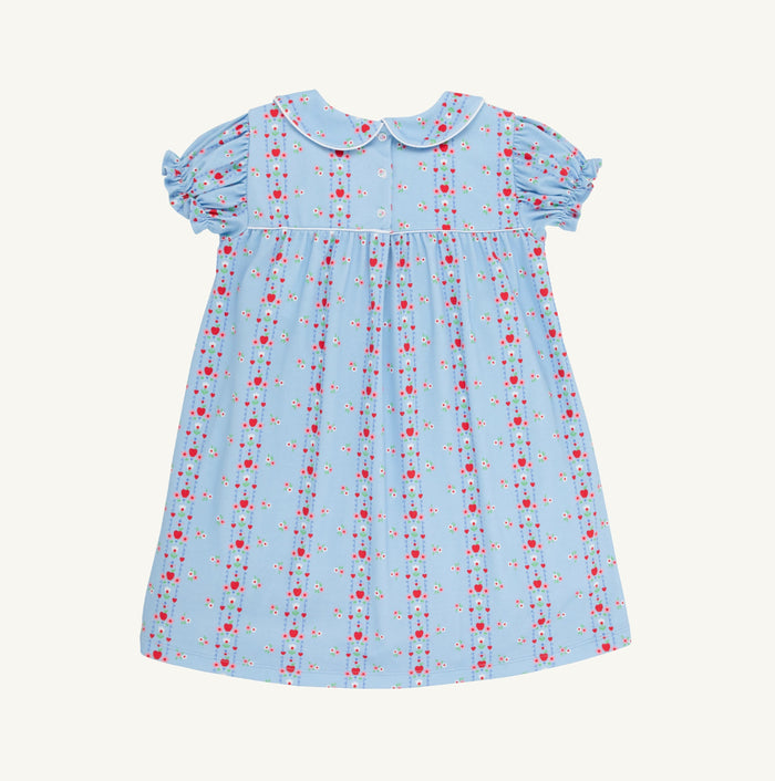 Celebrate new beginnings with the Holly Day Dress in First Day Flowers by The Beaufort Bonnet Company. Its charming floral pattern weaves in school details, while the classic silhouette and sweet Peter Pan collar make your little girl’s first day unforgettable—and every day after just as special!