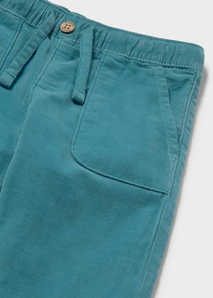 Soft corduroy infant pants in a rich teal tone, crafted with a cozy striped jersey lining for all-day comfort. The fabric make these an everyday essential that pairs beautifully with the Mayoral Bear Sweater for a coordinated look. Perfect for layering through seasons, these pants bring texture and warmth to your little one's wardrobe.