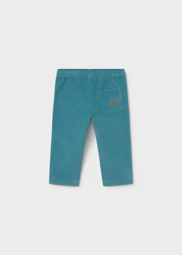 Soft corduroy infant pants in a rich teal tone, crafted with a cozy striped jersey lining for all-day comfort. The fabric make these an everyday essential that pairs beautifully with the Mayoral Bear Sweater for a coordinated look. Perfect for layering through seasons, these pants bring texture and warmth to your little one's wardrobe.