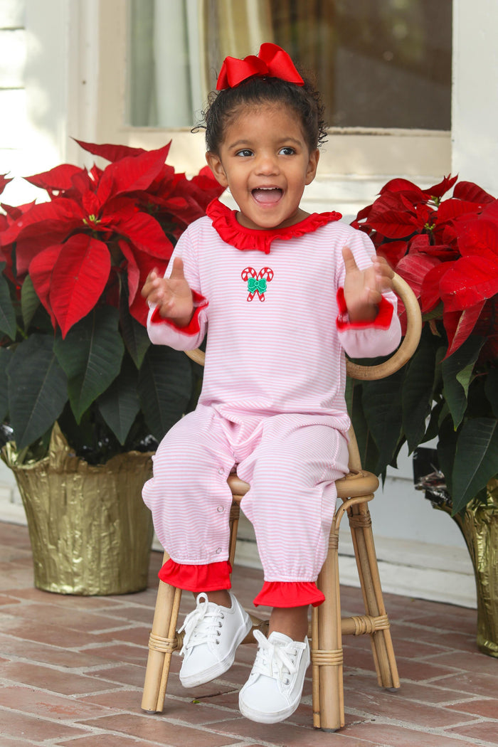 Infant Girls Candy Cane Ruffle Romper from Trotter Street Kids. This delightful outfit features sweet candy cane embroidery on the front pockets, adding a playful holiday touch.&nbsp;