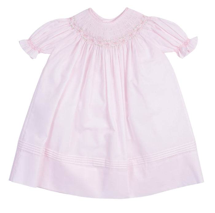 The Infant Girls Ruffle Sleeve Bishop Dress by Feltman Brothers is a delightful blend of elegance and charm. Its soft pink hue, classic smocking, and ruffle sleeves create an enchanting look, perfect for capturing precious moments. This heirloom-quality piece promises to be cherished for years to come!