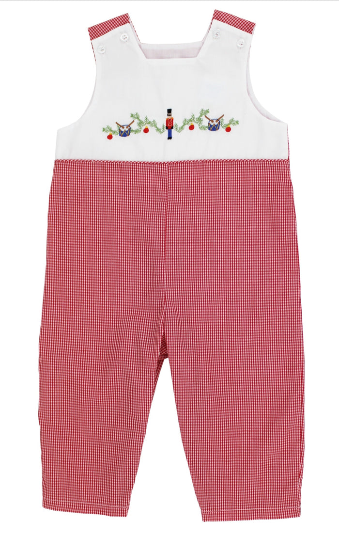 Celebrate the magic of the season with the Nutcracker Jon Jon by Bailey Boys. This charming red mini check gingham jon Jon, detailed with delicate nutcracker embroidery, brings holiday joy to your little one’s wardrobe. Paired with a crisp white Peter Pan collar shirt, it’s a timeless festive look.