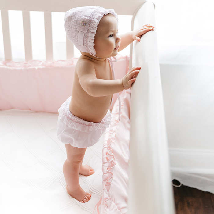 Dress your little one in the enchanting Secret Garden Bloomers by Feltman Brothers. With delicate roses and charming ruffles, these pink bloomers are a timeless addition to any infant girl's wardrobe. The beautifully stitched waistband offers comfort and style, perfect for precious photo moments!