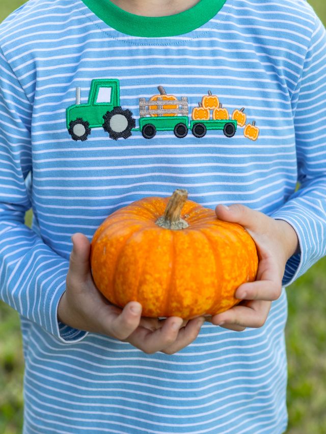 The Tractor Trail Pant Set by Trotter Street Kids brings autumn adventures to life with a charming striped tee featuring playful tractor and pumpkin appliqués, paired with cozy green pants—perfect for your toddler’s pumpkin patch days filled with comfort and fun!